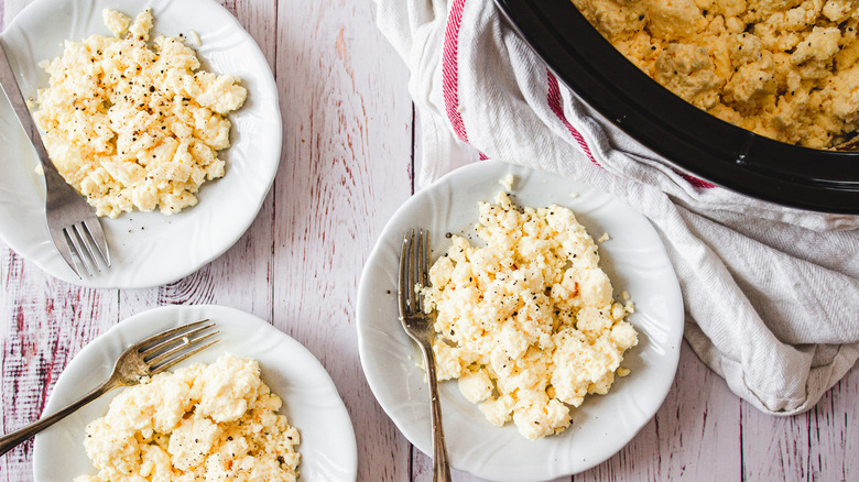 three plates of scrambled eggs