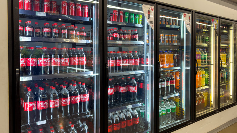 store refrigerator case filled with soda
