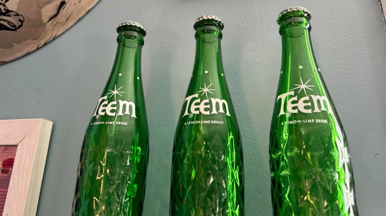 three empty bottles from Teem soda