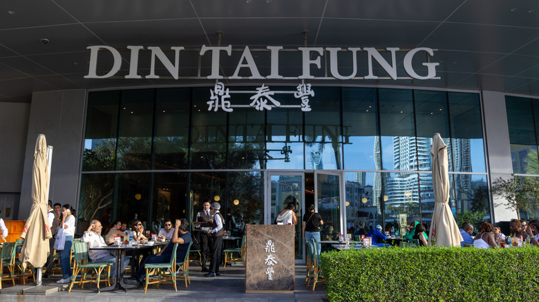 People eating outside of a Din Tai Fung restaurant