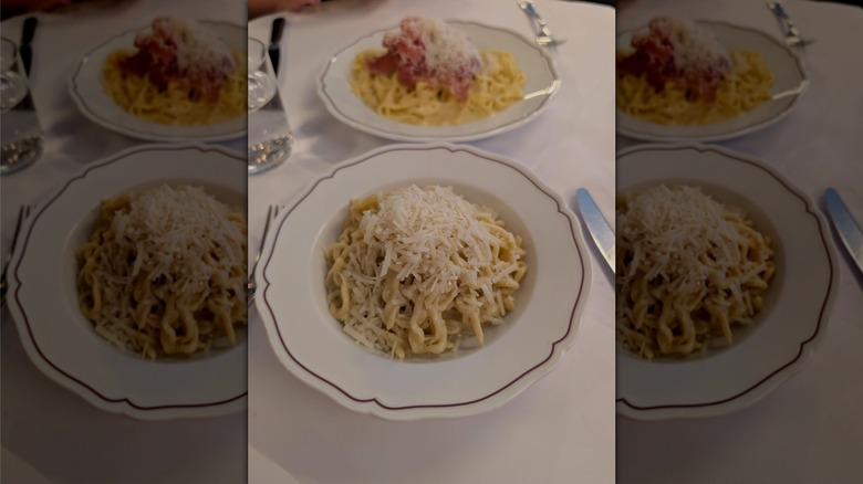bowl of cacio e pepe topped with grated cheese on dining table at Via Carota Italian restaurant in New York