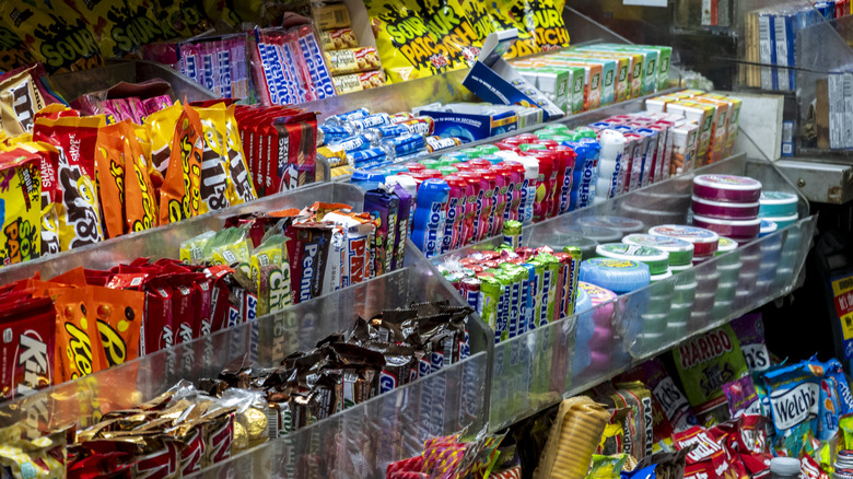 A candy display inside a grocery store.