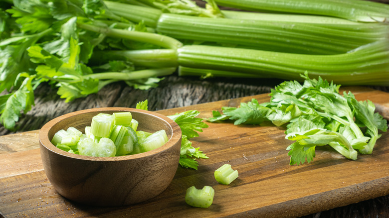 celery on a brown cutting board