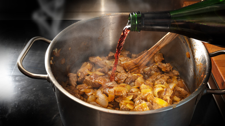 Red wine being poured into a pot