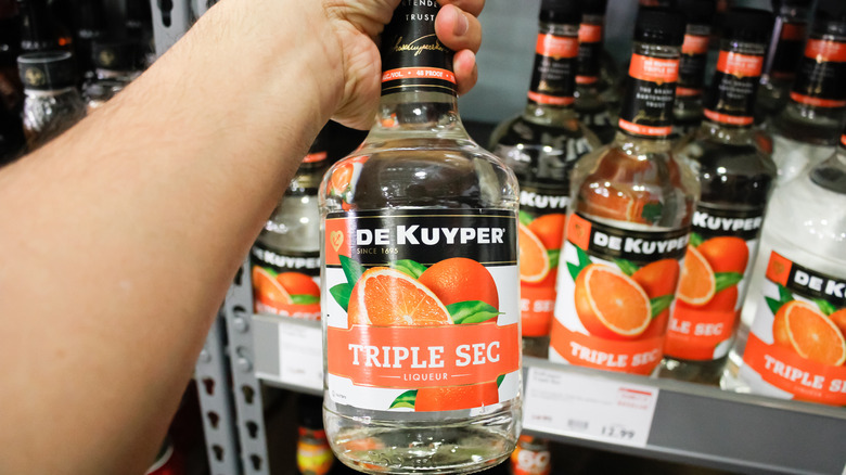 Shelf of triple sec bottles