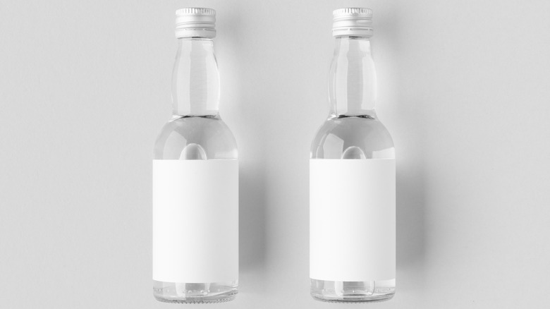 Two unlabeled bottles of vodka