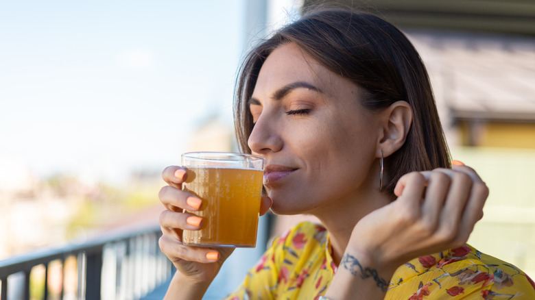 Woman smelling a glass of beer