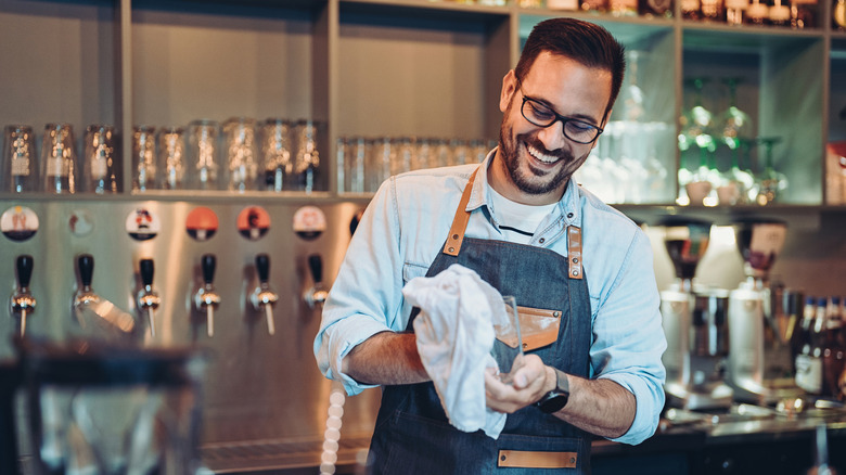 Bartender wiping glasses