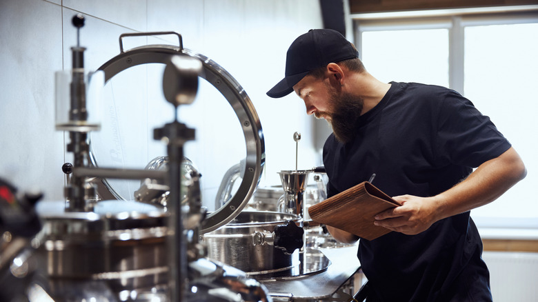 Man with clipboard in brewery