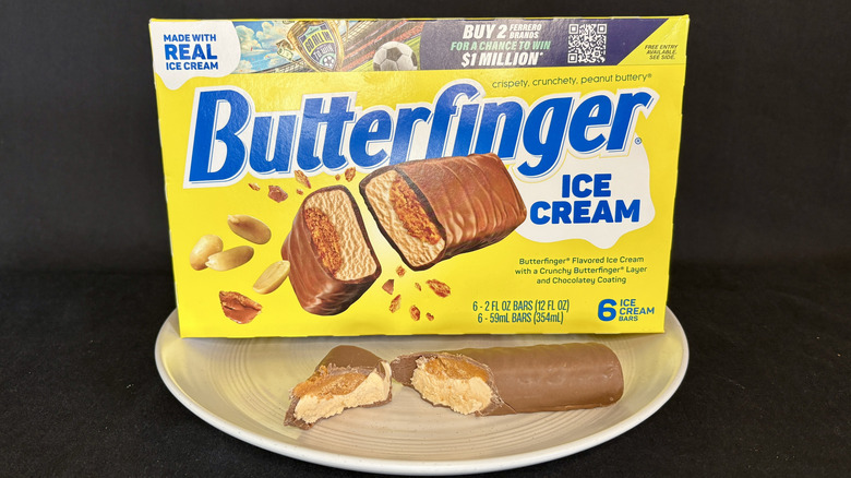 Butterfinger ice cream bar cut open on plate with box in background