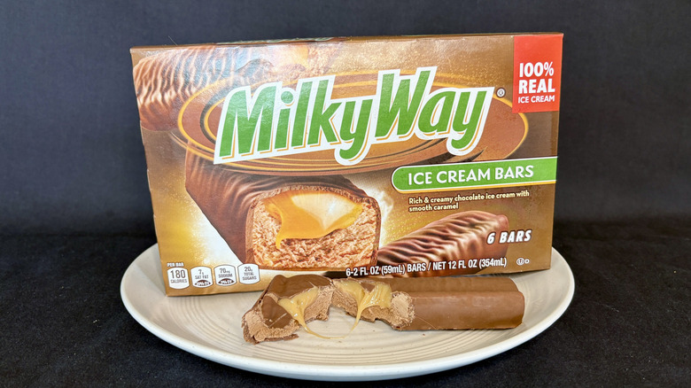 Milky Way ice cream bar cut open on plate with box in background