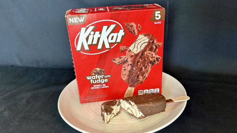 KitKat ice cream bar cut open on plate with box in background