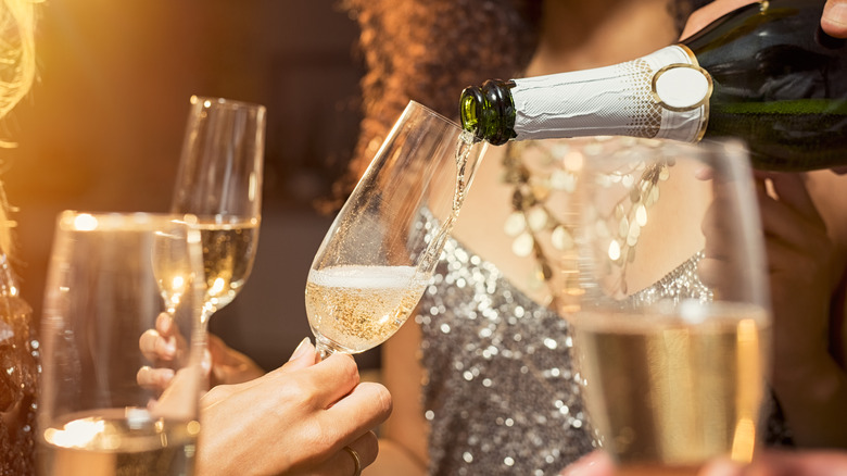 Pouring champagne into glasses