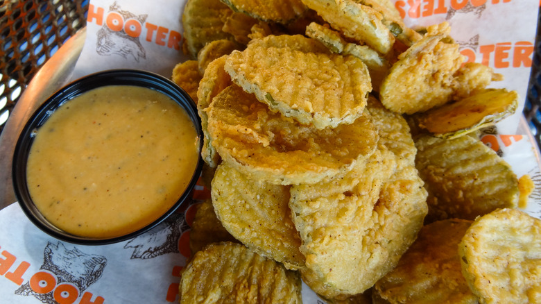 Dill pickle chips from hooters on a tray