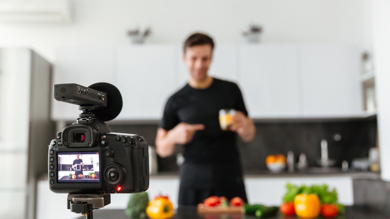 blurry man filming food content