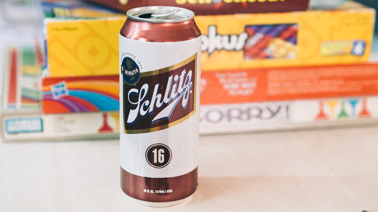 can of Schlitz with board games