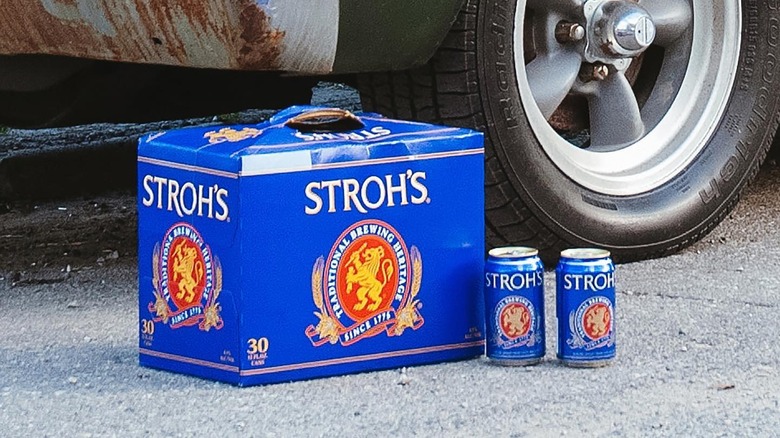 box and cans of Strohs beer