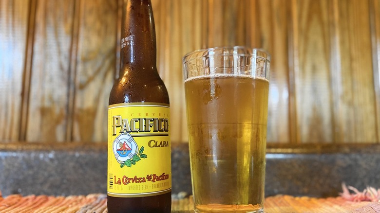 Pacifico Clara bottle next to glass of beer
