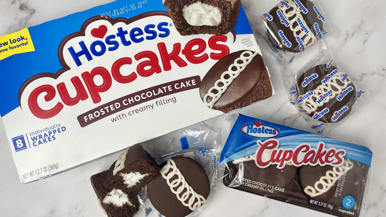 A box and packages of Hostess Frosted Chocolate Cupcakes with creamy filling