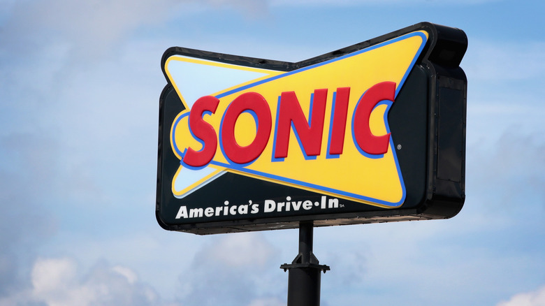 Close-up of an outdoor signage post for Sonic Drive-in