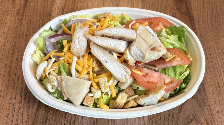bowl with salad and chicken on top