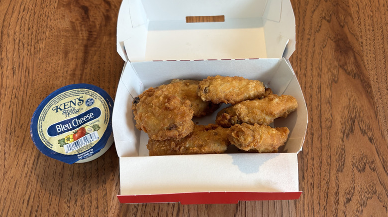 unsauced wings with side of blue cheese dressing cup