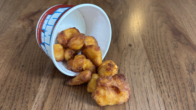 cheese curds spilling out of Sheetz carton onto table