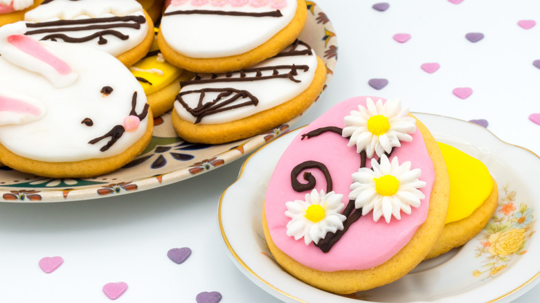 Two plates of Easter biscuits with colorful fondant designs