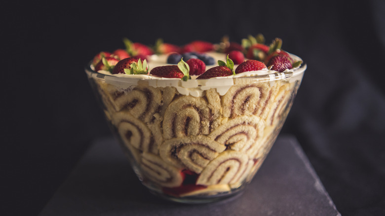 Strawberry trifle cake with custard in a large glass bowl