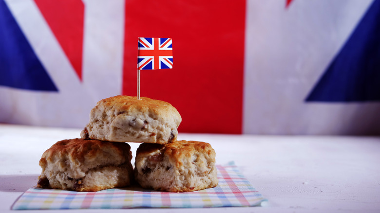A pyramid of three scones with a tiny Union Jack flag on a toothpick stuck on top
