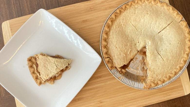 Sara Lee apple pie on plate and wooden cutting board