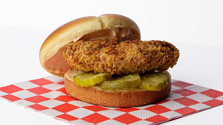 Fried chicken sandwich on a red checkered napkin