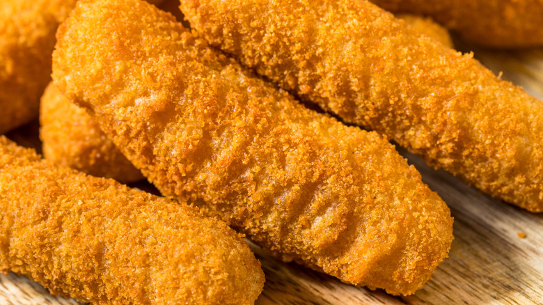 Close-up of mozzarella sticks on a wooden surface