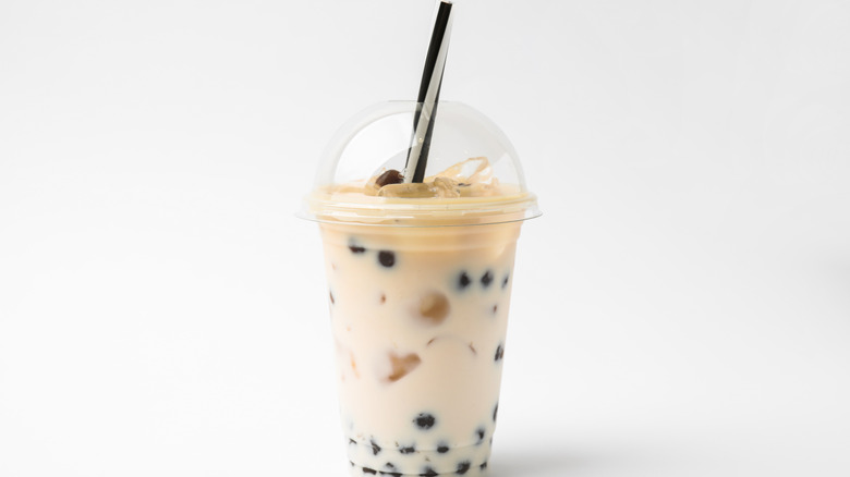 Plastic cup of bubble tea on a white background