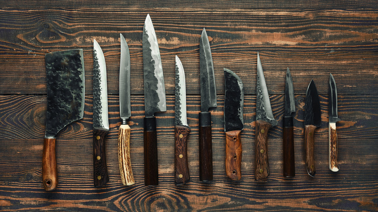 selection of classic kitchen knives on wooden table