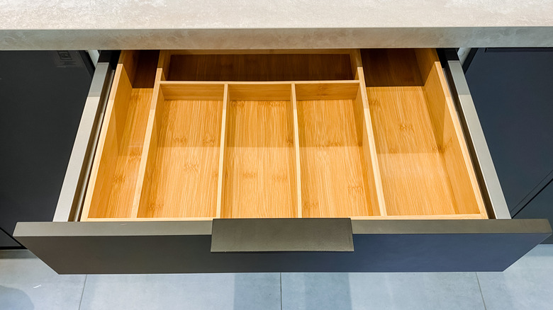 wooden silverware organizer in sleek, modern kitchen drawer