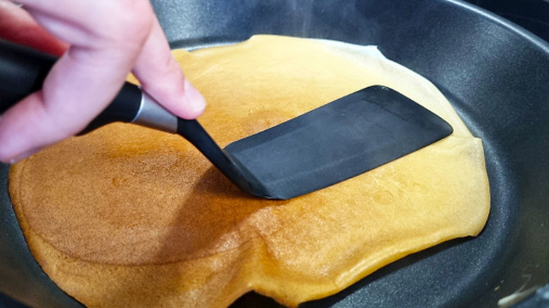 Pressing on pancake with spatula