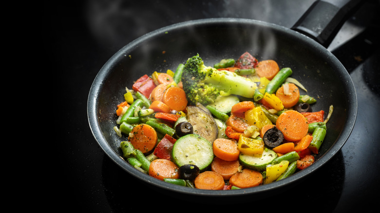 Vegetables frying in pan