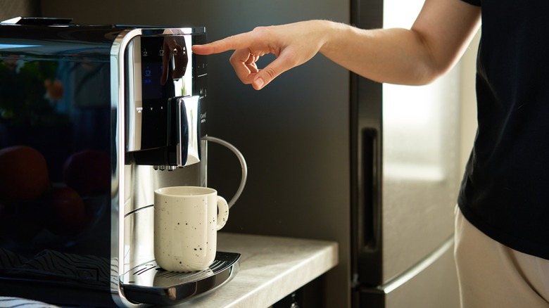 woman making coffee using home brewer