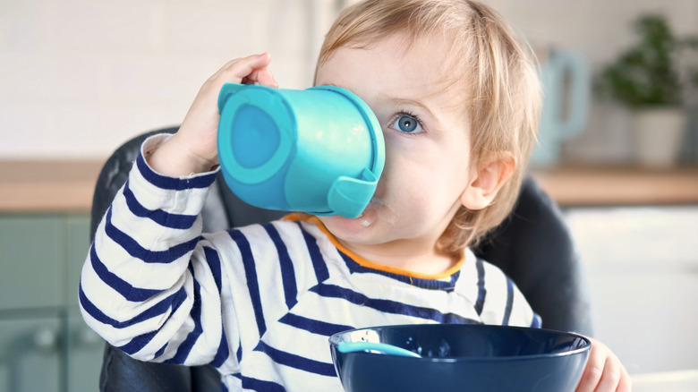 toddler drinking from sippy cup