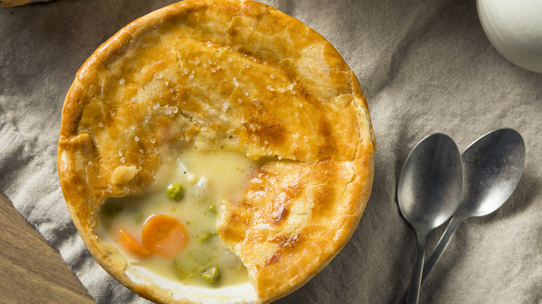 aerial photo of a chicken pot pie next to two spoons