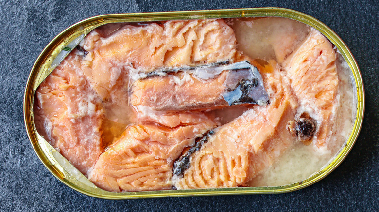 Close-up of an oblong open can of salmon in oil