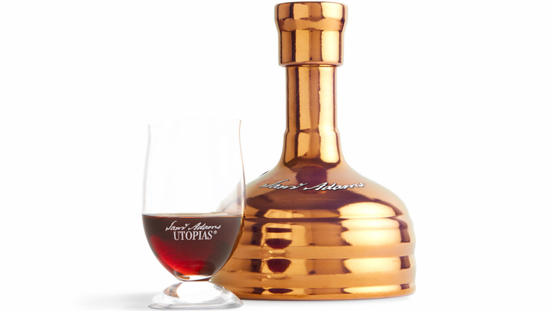 Utopias bottle beside a pour in a small glass
