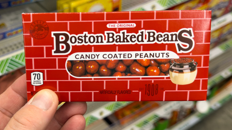 Close-up of a hand holding a box of Boston Baked Beans candy