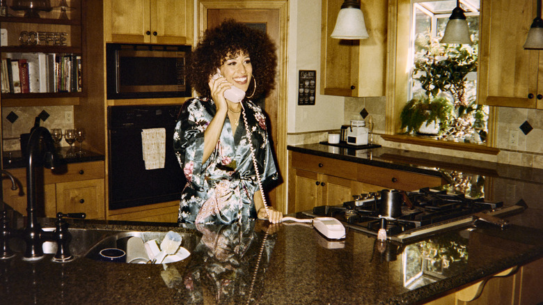 woman on the phone in her kitchen in the 1980s