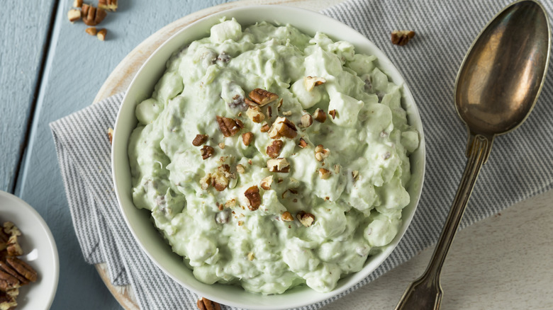 A bowl of Jell-O fluff with pecans on top