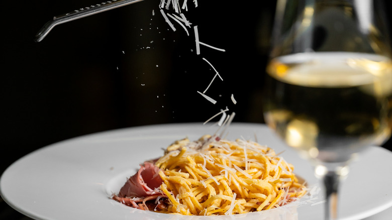 Grating cheese on pasta