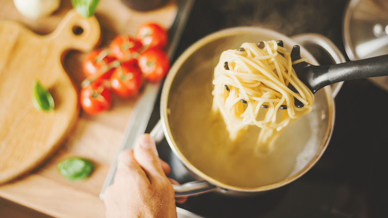 Lifting pasta from cooking water