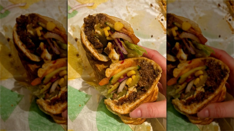 Subway sandwich in two halves containing steak and veggies