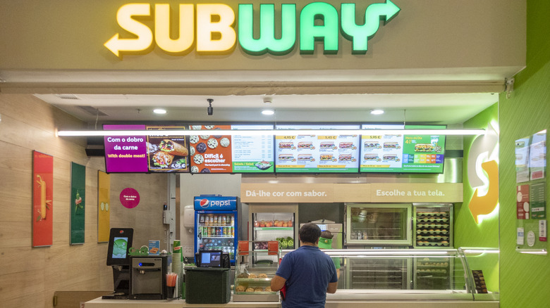 customer waiting for his sandwich at a subway in portugal